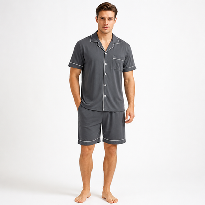 Man wearing a charcoal grey EiderWeave bamboo loungewear shorts set with piped trim