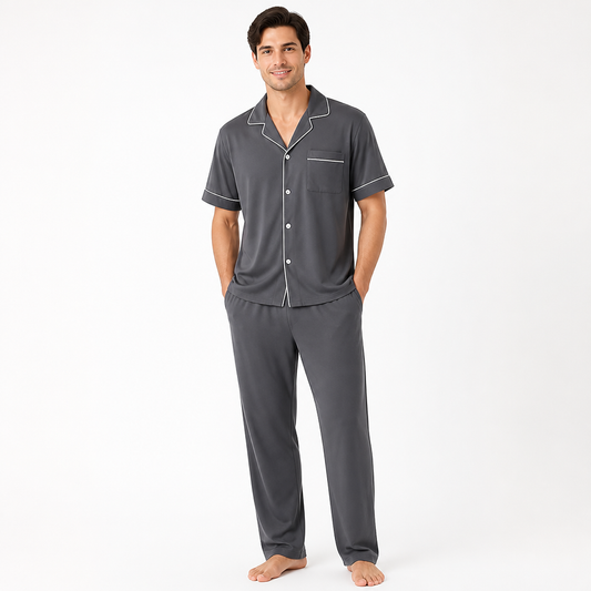 Man wearing a charcoal grey EiderWeave bamboo pajama set with short-sleeve top and trousers